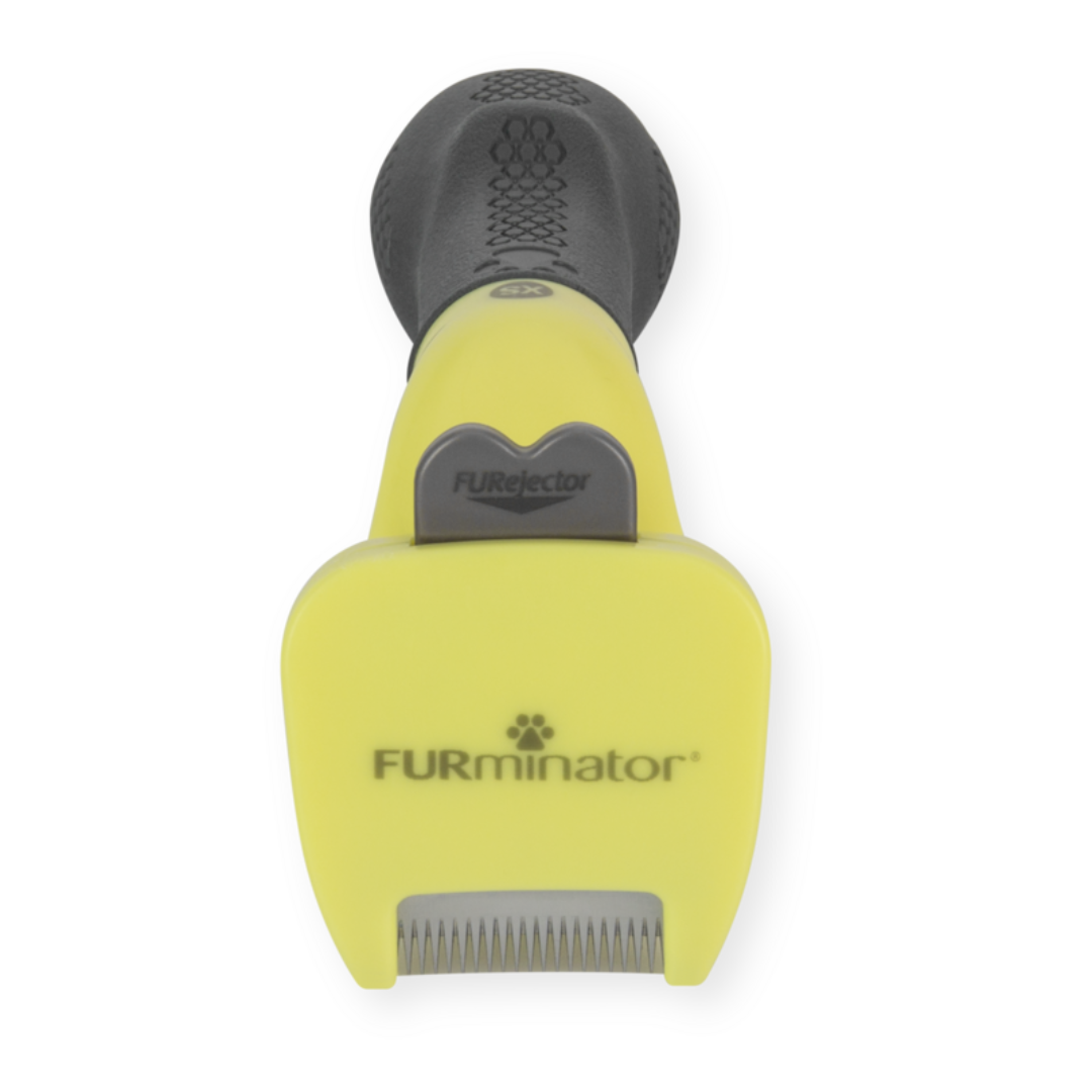 FURminator XS pour chiens à poils longs, vue de face avec bouton FURejector et lame anti-mue visible